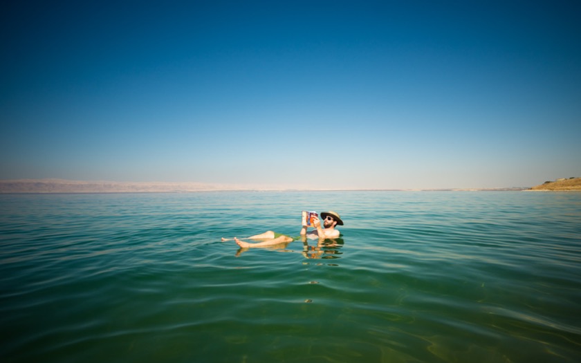 Reading a book in the Dead Sea