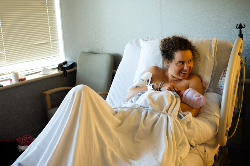 rachael holding baby in bed